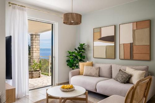 a living room with a couch and a table at Villas Muscalas by Konnect, 200m from the Beach in Lákka