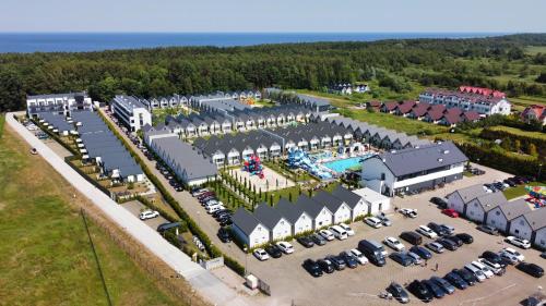 an aerial view of a parking lot with a pool at Holiday Park & Resort Grzybowo in Grzybowo