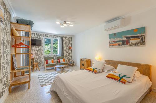 a bedroom with a bed and a living room at Beau studio dans mas provençal in Avignon