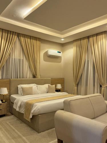 a bedroom with a large bed and a couch at Roseann Gold Boutique Hotel in Kusafe