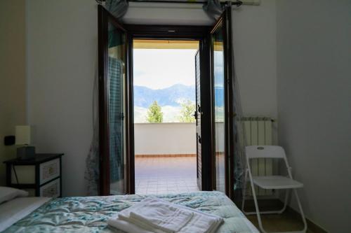 a bedroom with a bed and a view of a balcony at Introdacqua Holidays in Sulmona