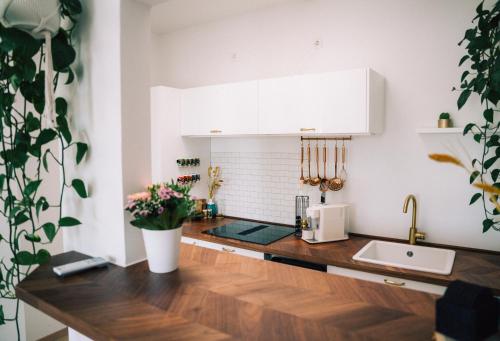 a kitchen with white cabinets and a wooden counter top at The Blasky in Frankfurt