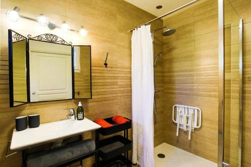 a bathroom with a sink and a shower at Studio Le Jardin in Lison