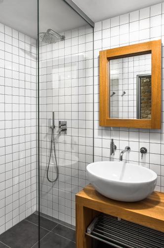 a bathroom with a sink and a mirror and a shower at Apartmány Vinařství Václav in Hustopeče