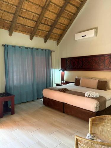 a bedroom with a large bed in a room at Ekori Lodge in Mamuno