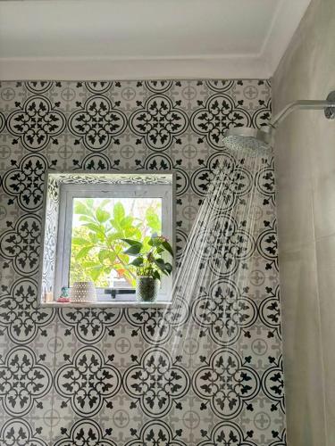 a bathroom with a shower and a window at Eagles Nest in Kirstenhof