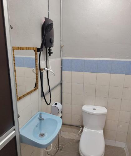 a bathroom with a toilet and a sink at GP StayIn in Lunas