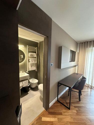 ein Badezimmer mit Toilette, Waschbecken und Tisch in der Unterkunft Atlantic Park Hotel in Fiuggi
