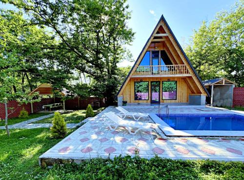 a house with a swimming pool with a roof at Qafqaz A-Frame Chalet Gabala in Gabala
