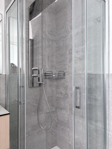 a shower with a glass door in a bathroom at Monica's Loft in Domodossola