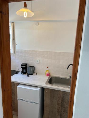 a kitchen with a sink and a counter top at Gardenia studios in Nydri