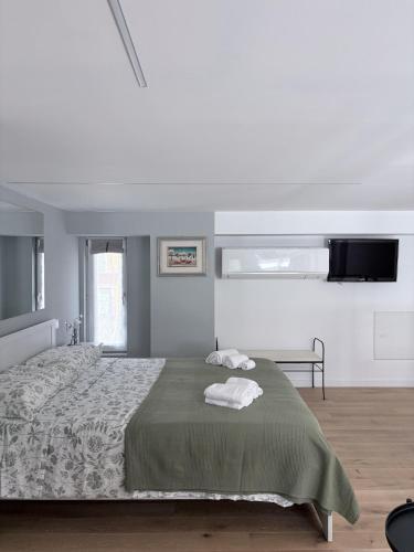 a bedroom with a bed with two towels on it at Monica's Loft in Domodossola