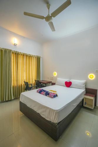 a bedroom with a large bed and a table at Palm Beach View Resort Cherai in Cherai Beach