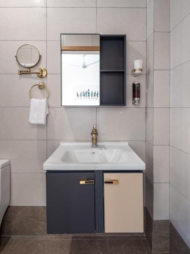 a bathroom with a sink and a window at Tulip Residences Vipingo Mombasa in Mombasa