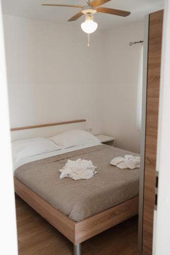 a bedroom with a bed with two towels on it at EUCALYPTUS in Nerezine