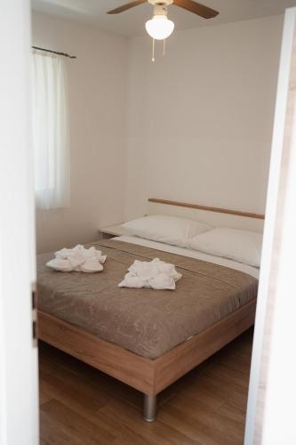 a bedroom with a bed with towels on it at LAVANDLA in Nerezine