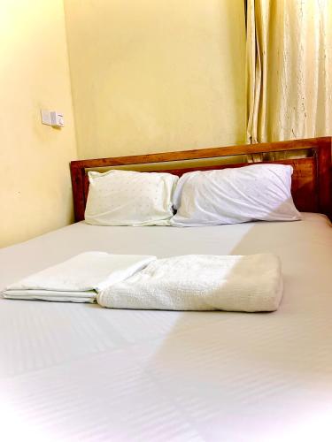 two white towels sitting on top of a bed at Studio Kilifi -Pendoraha Homes in Kilifi