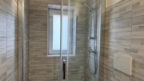 a shower with a glass door in a bathroom at La Casa di Katia in Pisa