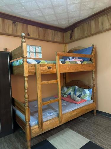 a bedroom with bunk beds in a room at Sagada Pinewood Lodge basement in Sagada