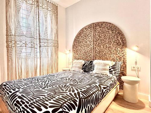 a bedroom with a large bed with a large headboard at Jazmin 6 ( whole apartment ) in Alicante