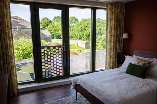 a bedroom with a bed and a large window at Market Square in Monasterevin