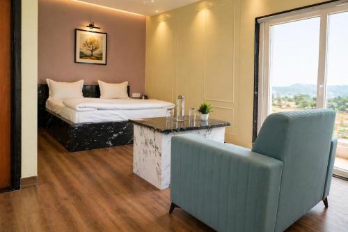 a bedroom with a bed and a couch and a chair at Hotel Amarsar Palace in Amarsar