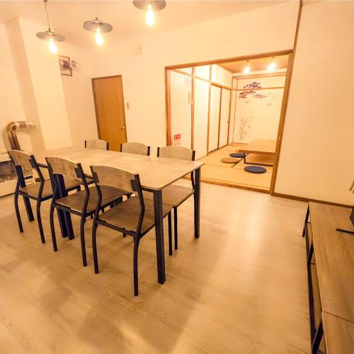 a dining room with a table and chairs at Snow Veil Iwamizawa in Iwamizawa
