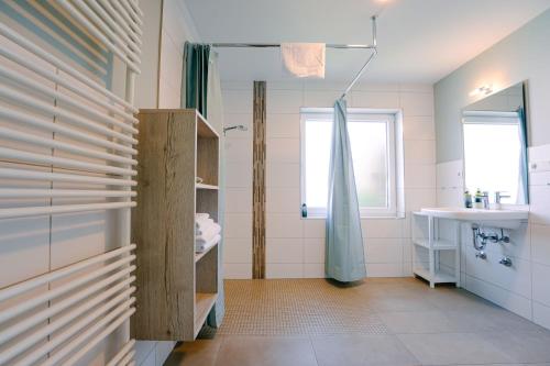 a bathroom with a shower and a sink at Hotel Waastwinj in Utersum