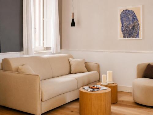 a living room with a couch and a table at Numa Rome Condotti in Rome