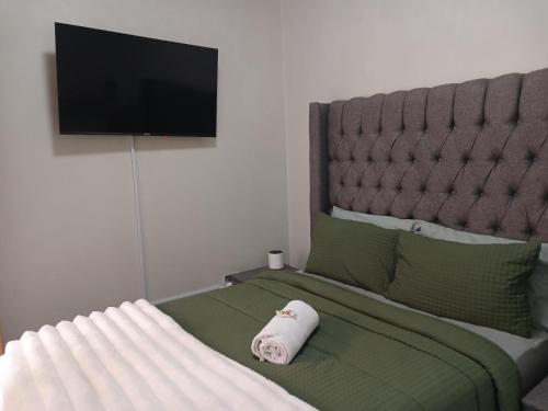 a bedroom with a bed with a towel on it at Ficus self catering in Burgersfort