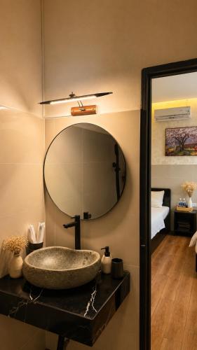 a bathroom with a sink and a mirror at Nếp Nhà Homestay in Tân Phú