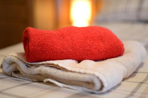 a red pillow sitting on top of towels on a counter at Derg Valley Apartments in Castlederg