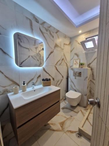a bathroom with a sink and a toilet at Peter's Village in Kalamaki Messinia