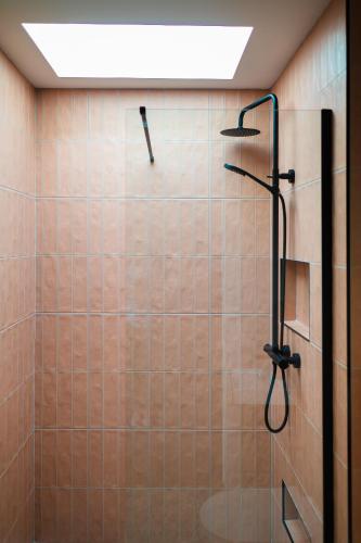 a bathroom with a shower with a shower head at Market Square in Monasterevin