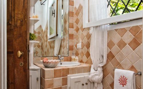 a bathroom with a sink and a mirror at Amazing Two-Bedroom House with Sea View in Cala di Volpe in Porto Cervo