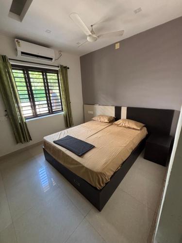 a bedroom with a large bed in a room at Grand Retreat in Trichūr