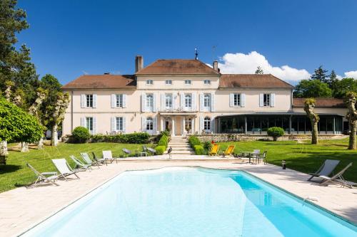 a large house with a swimming pool in front of it at Château Du Mont Joly in Sampans