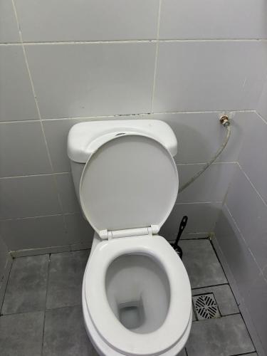 a bathroom with a white toilet in a stall at Studio Kilifi -Pendoraha Homes in Kilifi