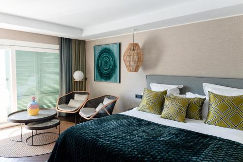 a bedroom with a bed and a table and chairs at Boho Club Marbella - a Preferred Hotel in Marbella