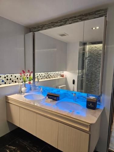 a bathroom with two sinks and a large mirror at Blue Sky Private Pool Villa in Chiang Mai