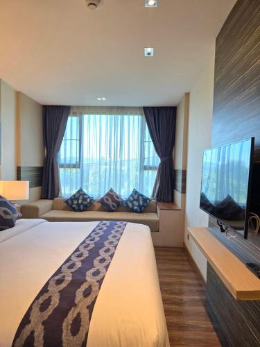 a hotel room with a bed and a flat screen tv at Blue Sky Private Pool Villa in Chiang Mai