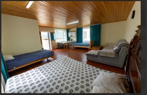 a living room with two beds and a couch at Terelj Khangai Resort in Belen Hüryee Hiid