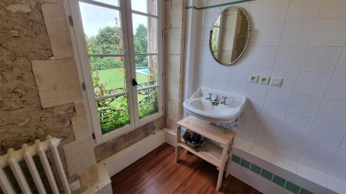 a bathroom with a sink and a window at Domaine de Chaunac in Chaunac