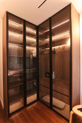 a walk in closet with glass doors at ModernApartmentsBL in Banja Luka