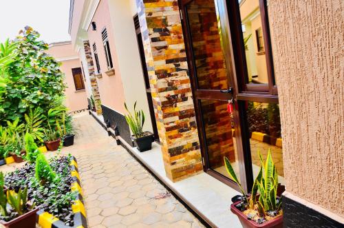 a courtyard with potted plants in a building at Townside Suites in Kyebando