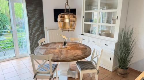 a dining room with a wooden table and chairs at Haus Katharina, Balkon mit Meerblick in Lauterbach