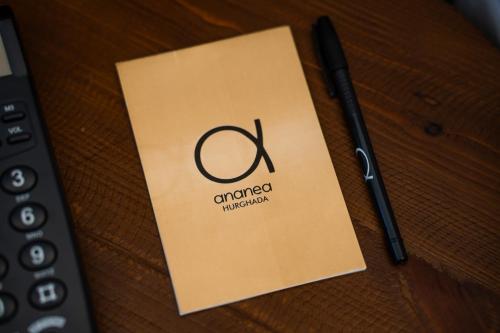 a piece of paper with the word compounded on it next to a pen at ananea Hurghada - Adults Only in Hurghada