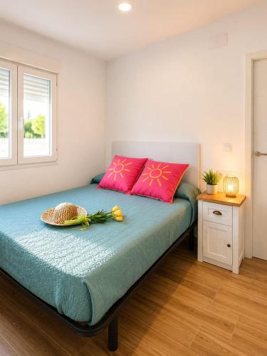 a bedroom with a bed with a basket on it at Casa Aljubet in Onil