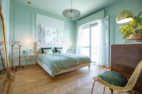 a bedroom with a bed and a chair in it at Lake House Lesa - Lakeside Villa Lago Maggiore in Lesa