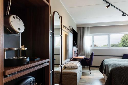 a hotel room with a bed and a desk at Scandic Hvidovre in Hvidovre